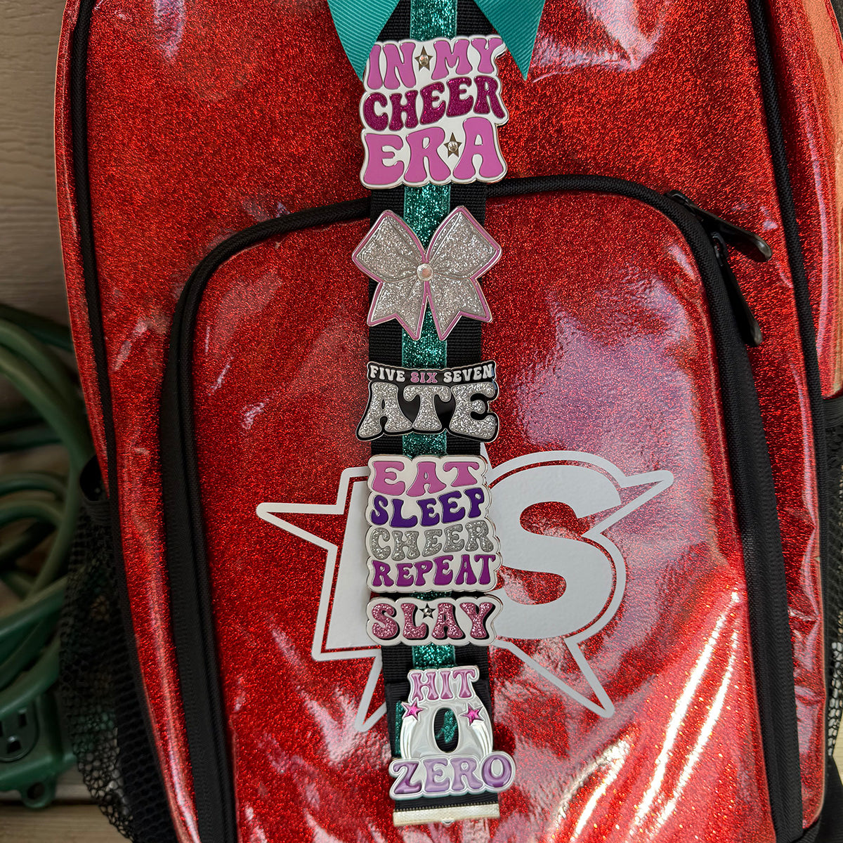 Five Six Seven Ate Cheer pin for backpacks by Bella Forge Pink pink white silver glitter and black on red backpack