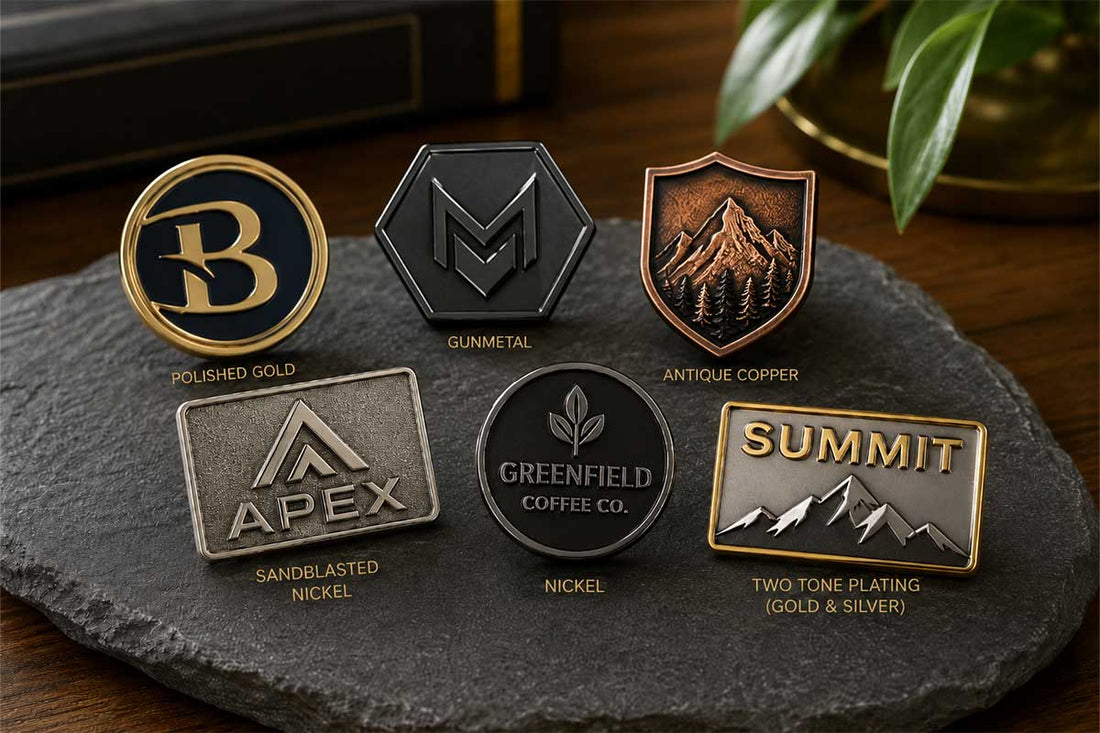 Custom branded lapel pins showing different finish options, polished gold, gunmetal, antique copper, sandblasted nickel, and two tone plating finishes.