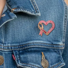 Breast Cancer Awareness Lapel Pin by Bella Forge Pink heart-shaped ribbon with engraved text  shown on a denim jacket